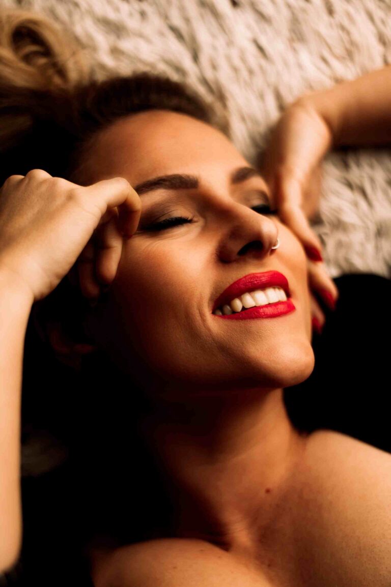 Woman lays ecstatically on luxurious fur bedding