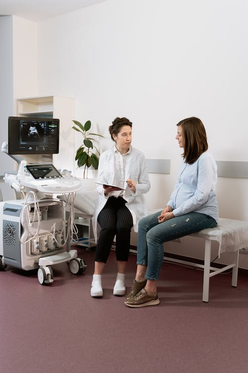 Pregnant woman in consultation with her doctor