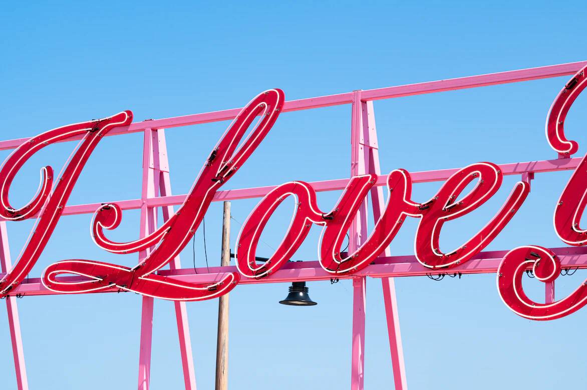 The word “love” captured on a neon sign. Masturbation relieves stress.