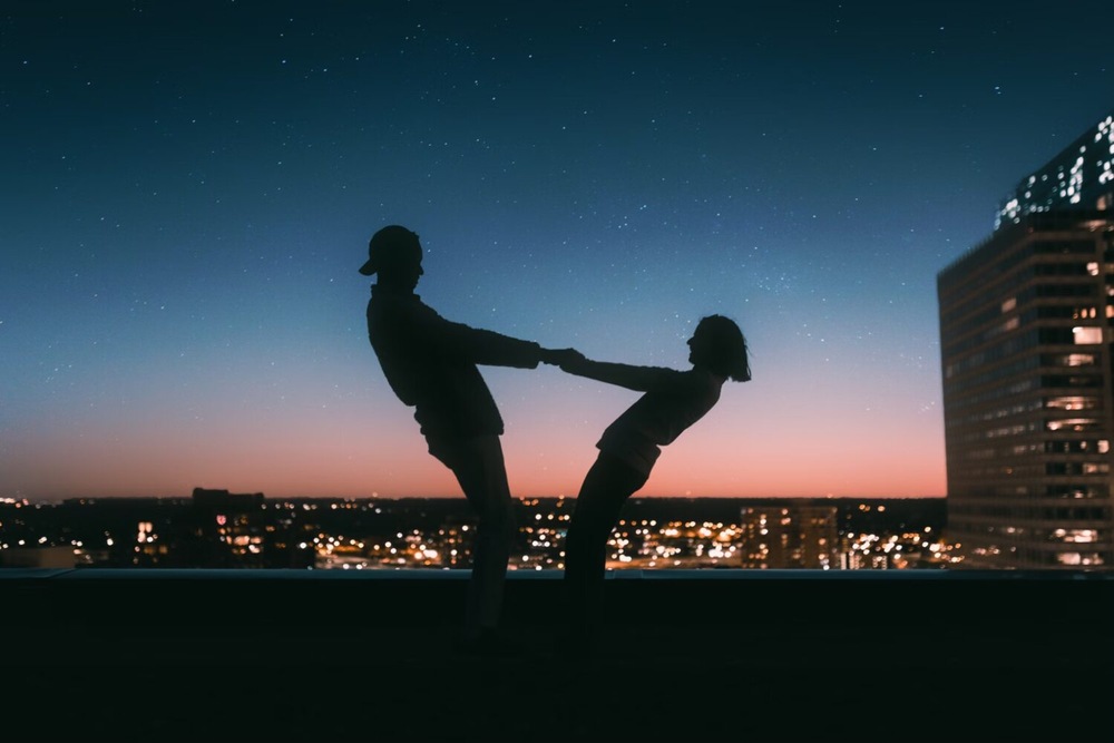Couple dancing on top of a building