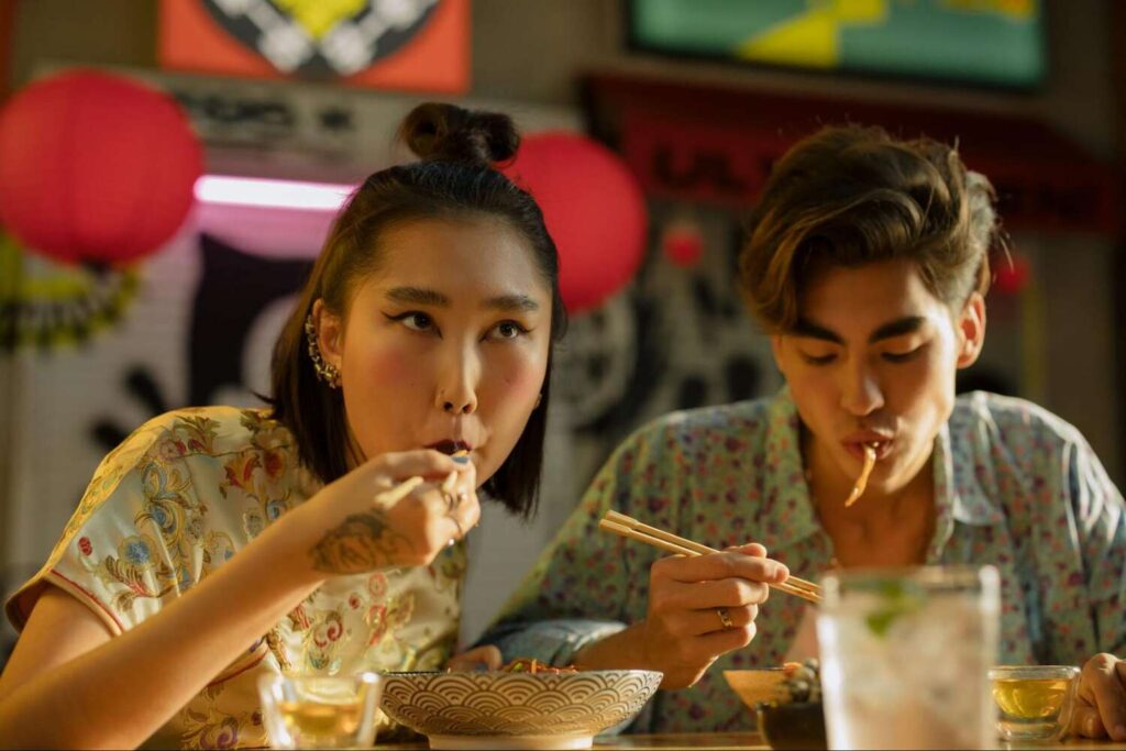 Man and woman eating with chopsticks